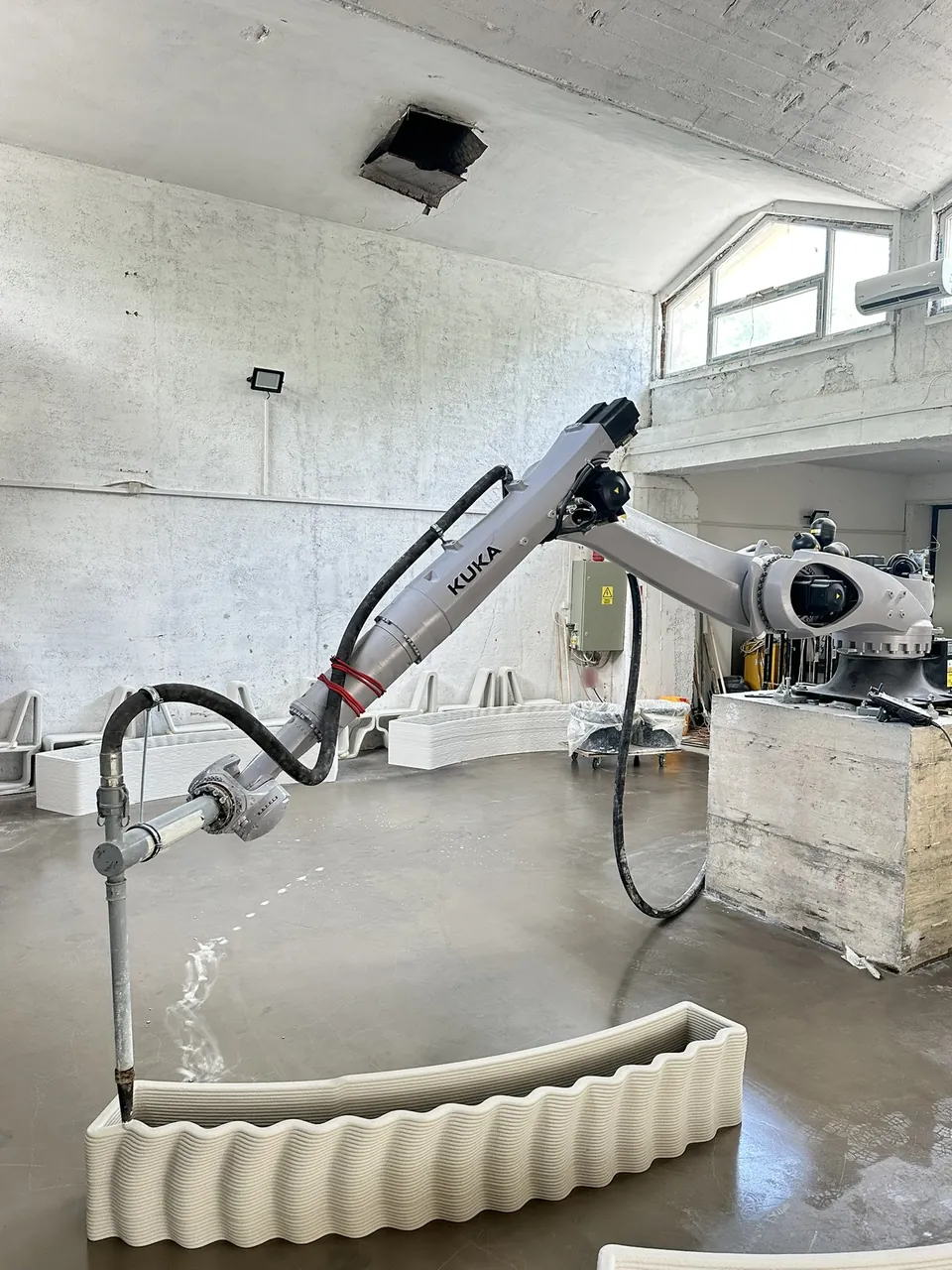 A desk section being printed by the robotic arm