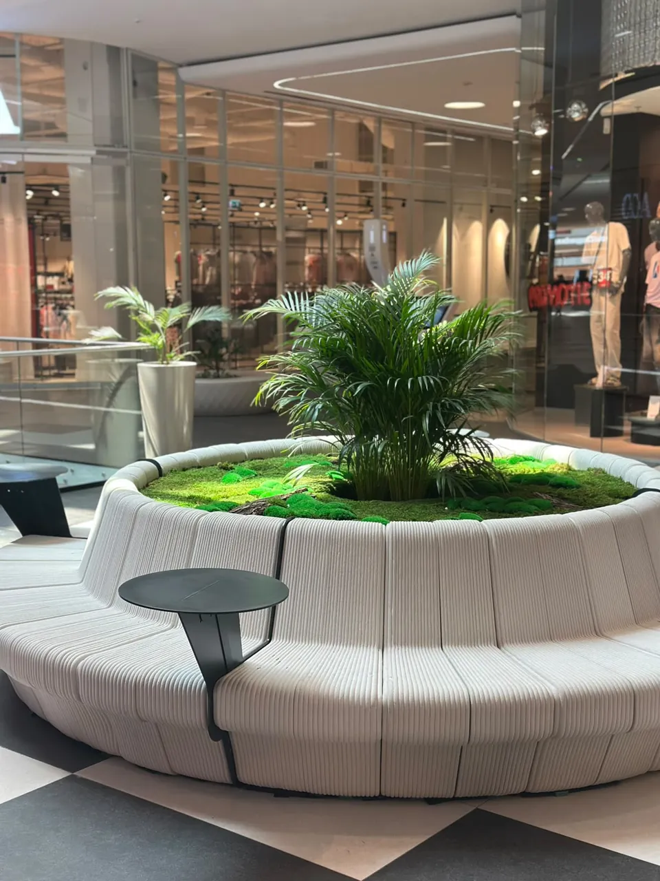 Round bench with a small table between the seats