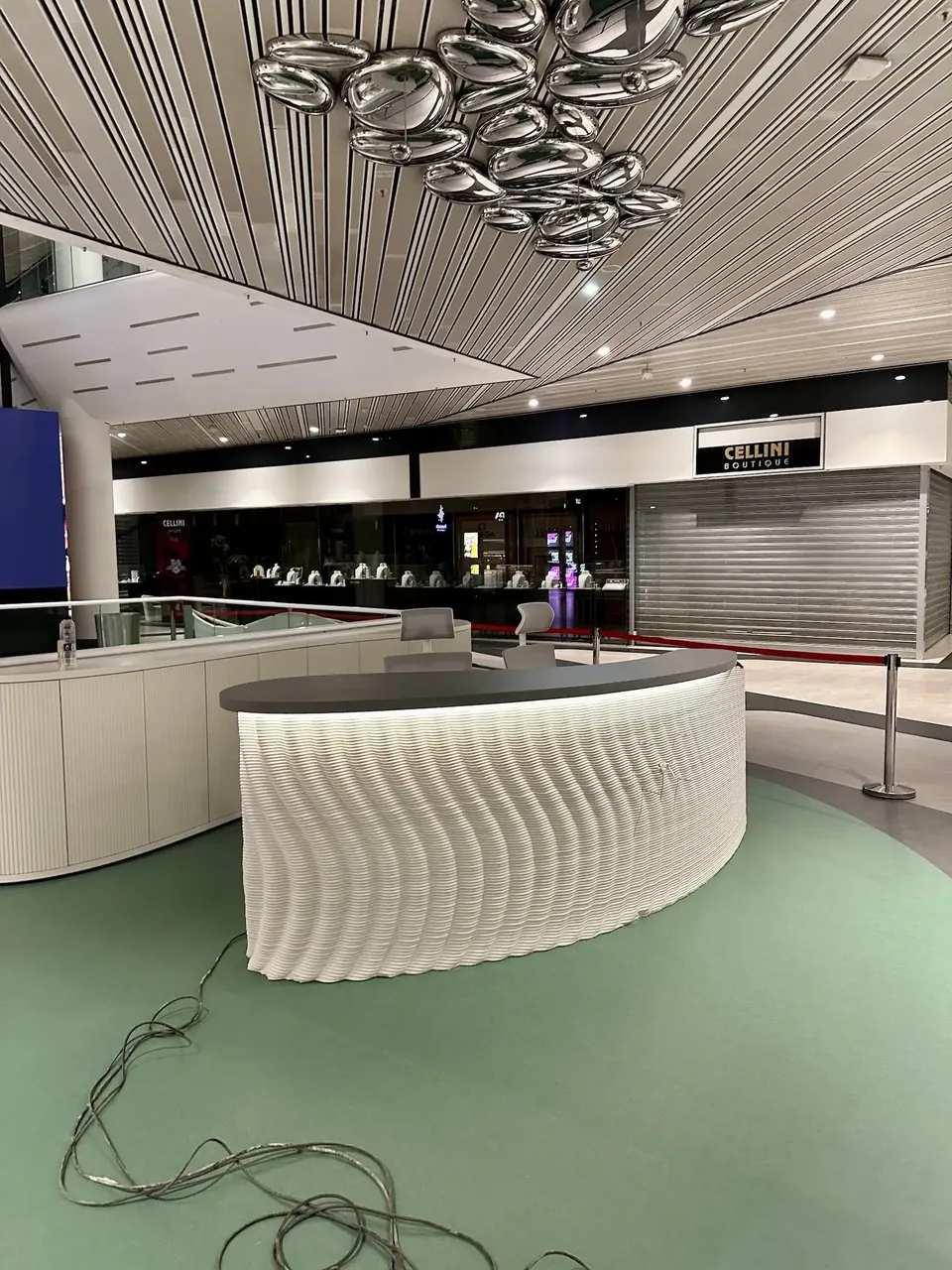 Curved printed info desk with a lit top