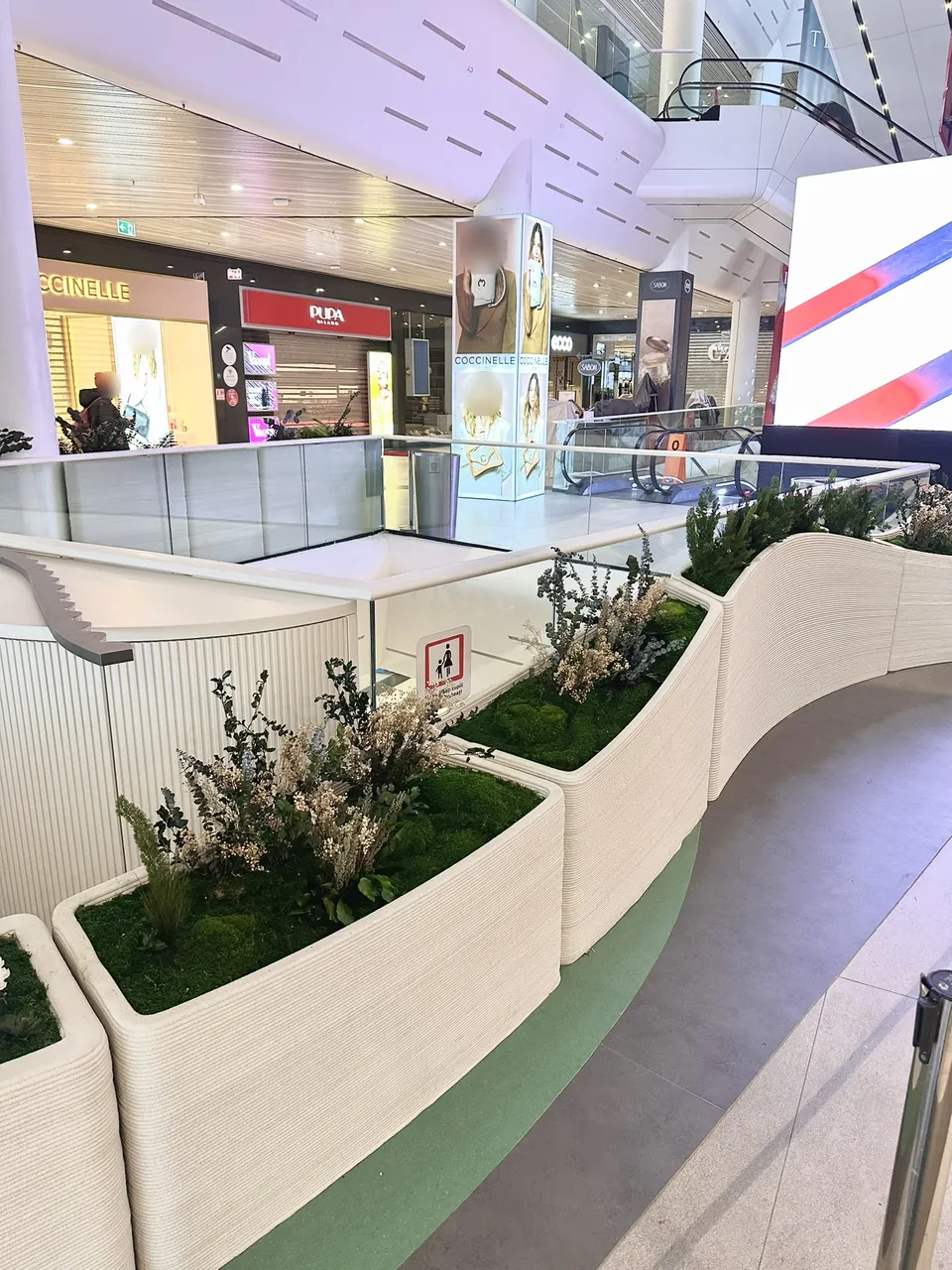 Long curved planters along the gallery