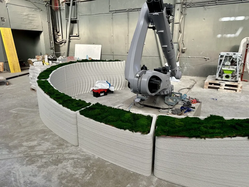 The robotic arm printing the planter sections in the workshop